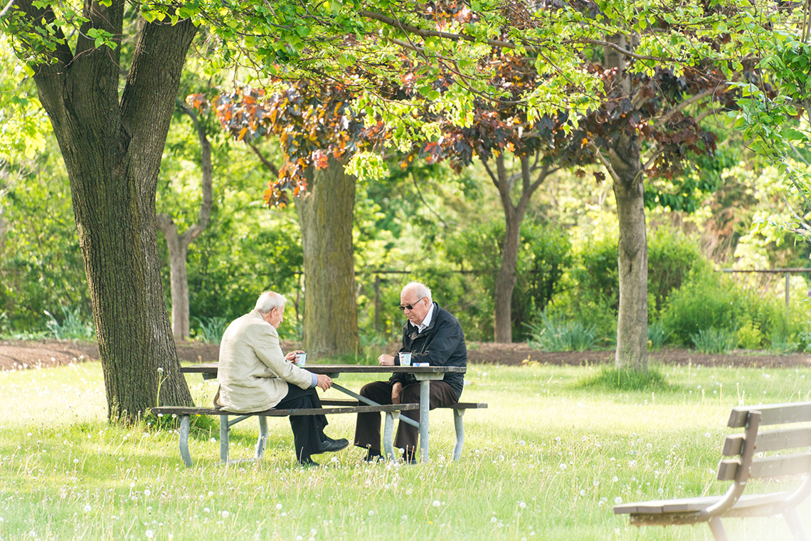 Two older men sitting in the park: "We are all eventually going to be older Torontonians," says Dr. Samir Sinha, an associate professor at the Institute of Health Policy, Management and Evaluation (Photo by Roberto Machado Noa/LightRocket via Getty Images